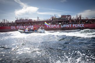 Activists from Greenpeace Nordic paint slogans on a bunker ship that fuels vessels from Russia’s shadow fleet in the open waters off the Swedish island of Gotland. April 12, 2024. 