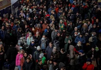 People in Kyiv wait to board an evacuation train to Lviv