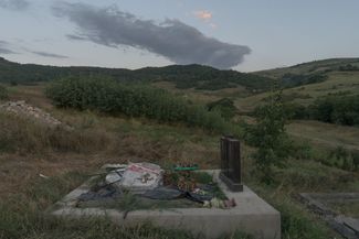 A cemetery in Chinari. After the war, villagers were afraid to bury their dead during the day. The cemetery is located within sight of an Azerbaijani military post. Armenia Tree Project volunteers and local residents planted poplar trees along the cemetery. When the trees mature, they will mark the location of the border.
