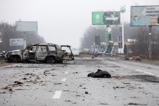 Тела и сгоревшие автомобили на шоссе недалеко от Киева.