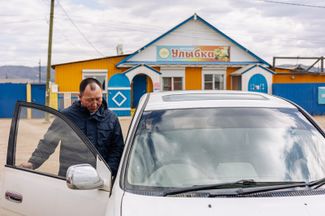 Village administration head Tsydendordzhi Buyantuyev keeps the keys to the memorial square in a nearby convenience store