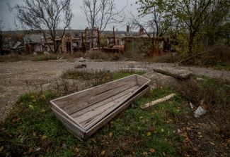 Пустые гробы возле домов в Северске, уничтоженных при обстрелах